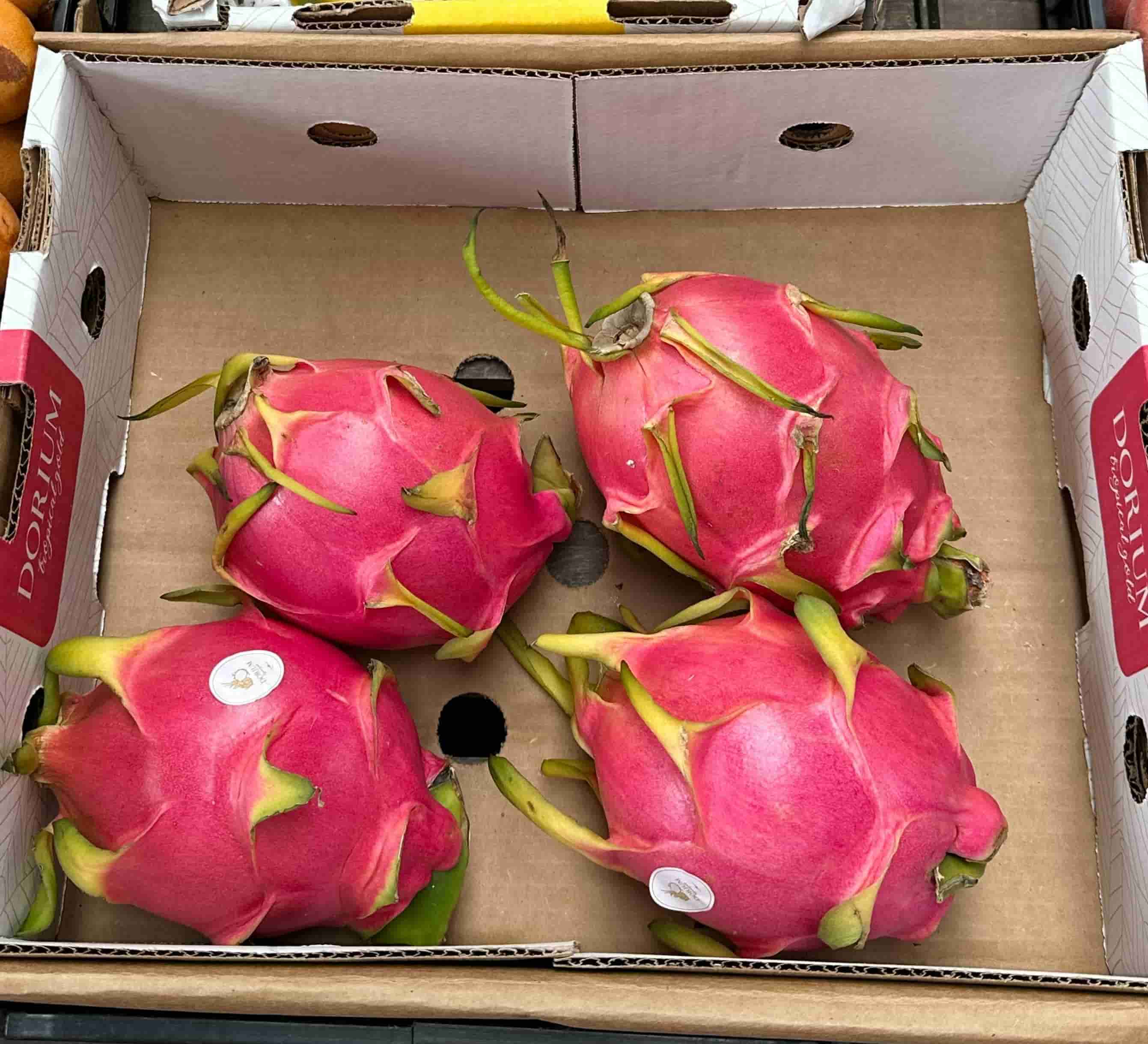 Red and white flesh dragon fruits on market stall